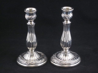 A pair of embossed silver candlesticks 5"