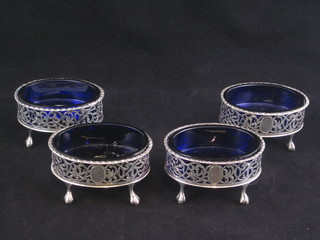 A set of 4 Edwardian oval pierced silver salts with blue glass liners, raised on cabriole supports, Chester 1908, 8 ozs   ILLUSTRATED