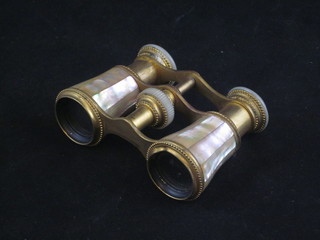 A pair of gilt metal and mother of pearl opera glasses by Edw.  Oelker of Ginginnati.o, slightly dented,