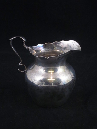 A Sterling silver cream jug by J E Caldwell & Co. base marked  925, dents, 2 ozs