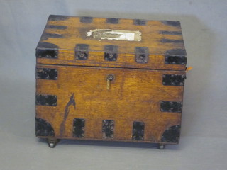 A Victorian oak and iron banded plate trunk with hinged lid 19"