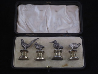 A set of 4 Edwardian silver place card holders in the form of game birds, the eyes set red hardstones, London 1906, makers  mark W H, cased
