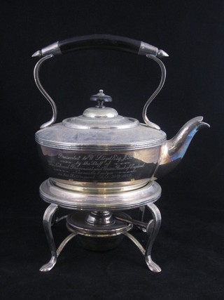 A circular silver plated tea kettle complete with burner