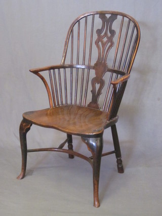 An 18th/19th Century elm Windsor tub back chair with pierced  vase shaped slat back and solid seat, raised on cabriole supports  with cow horn stretcher