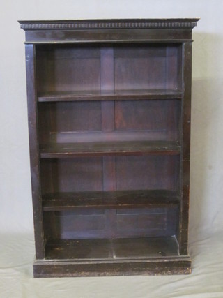 An Edwardian ebonised bookcase with moulded and dentil  cornice, the interior fitted adjustable shelves 30"