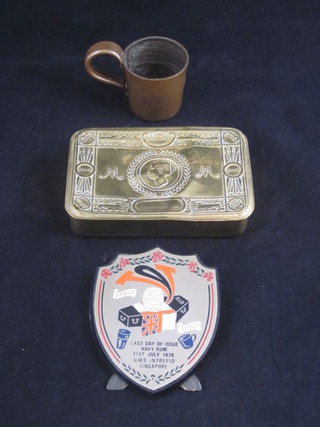A Princess Mary gift tin together with an enamelled shield to commemorate the last day of issue of rum to the Navy 31 July  1971 HMS Intrepid, together with a glass half gill measure