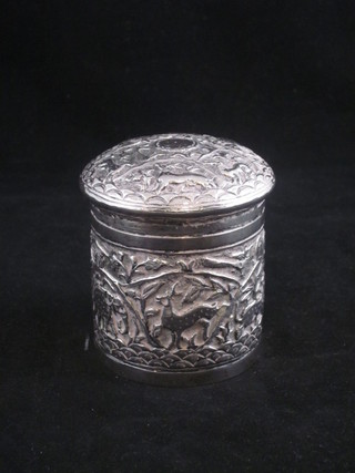 An Eastern cylindrical embossed silver jar and cover