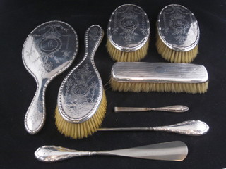 A 4 piece matched silver backed dressing table set with pair of clothes brushes, hand mirror and hair brush, together with silver  handled shoe horn, button hook and pair of tweezers