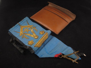 An 18th/19th Century blue Masonic sash with temple, square and compasses, gavel hung a gilt and white metal square and compass  jewel, contained in a leather carrying case, possibly Scottish,