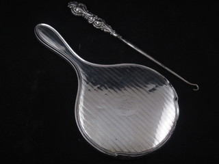 A silver backed hand mirror, no mirror, and a silver handled  button hook