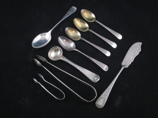 A pair of Georgian silver bright cut sugar tongs, a Georgian silver mustard spoon, a small pair of sugar tongs, a silver butter  knife, 5 various spoons, 5 ozs