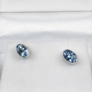 A pair of aquamarine and gold ear studs