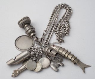 A silver curb link chain hung 2 silver whistles, a St Christopher  medal, a seal and an articulated fish