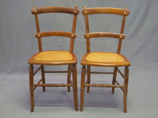 A pair of Edwardian walnut ladderback bedroom chairs with woven rush seats, raised on turned supports