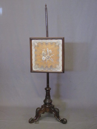 A Victorian mahogany fire screen with square bead work banner, raised on carved pillar and tripod support