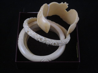 A carved ivory bangle and 3 others