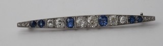 An Art Deco 18ct white gold or platinum boat shaped brooch set diamonds and sapphires