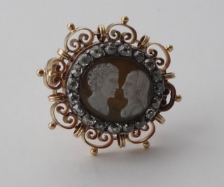 A carved shell cameo portrait brooch of a lady and gentleman, surrounded by diamonds and set in a mount