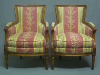 A pair of mahogany tub back chairs upholstered in pink and  cream floral material