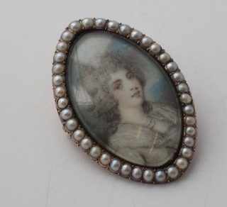 An 18th/19th Century oval portrait miniature of a lady contained  in an oval gilt metal locket/brooch, surrounded by demi-pearls