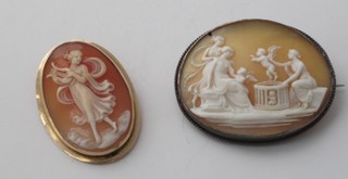 A shell carved cameo portrait brooch of a classical lady playing a lyre, together with an oval shell carved cameo portrait brooch  of a classical scene, cracked