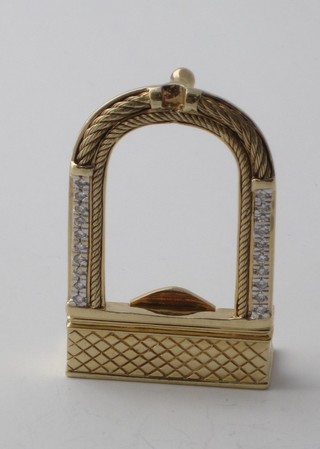 An 18ct gold arch shaped belt buckle set diamonds
