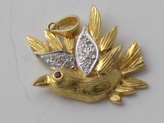 A gold pendant in the form of a bird set diamonds