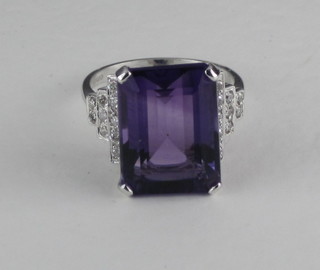 A lady's 18ct white gold dress ring set a rectangular cut amethyst and diamonds to the shoulders