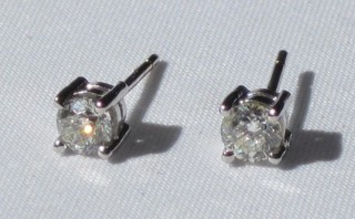 A pair of diamond stud earrings, approx 0.67ct