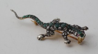 A gold brooch in the form of a lizard set rubies, emeralds and diamonds