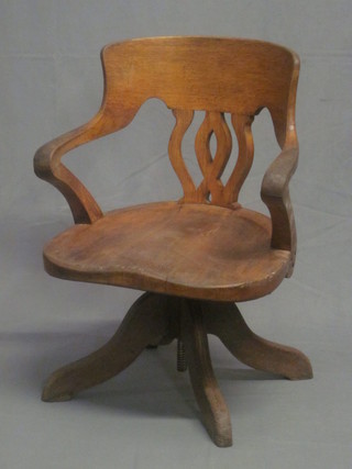 An Edwardian oak office swivel chair