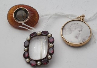A gold double sided photo locket, an amber coloured mourning brooch with hair sculpture and a rock crystal brooch