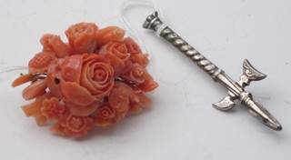 A coral floral shaped brooch and a silver brooch in the form of a Halbert