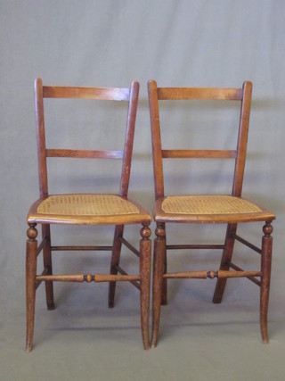 A pair of mahogany bar back bedroom chairs with woven rush  seats, raised on turned supports