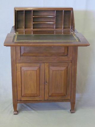 A mahogany "surprise" bureau with rising top, the base fitted a cupboard enclosed by a panelled door, raised on square tapering  supports 242