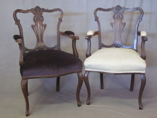 A pair of Edwardian mahogany open arm chairs with upholstered  seats and backs, raised on French cabriole supports