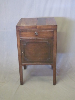 A Georgian mahogany enclosed wash stand with fitted interior,  the base fitted a cupboard enclosed by a panelled door, raised on  square tapering supports 19"