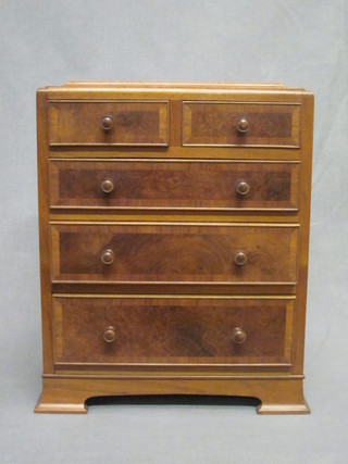 An Art Deco walnut apprentice chest with caddy top, fitted 2 short and 3 long drawers, raised on bracket feet 11"