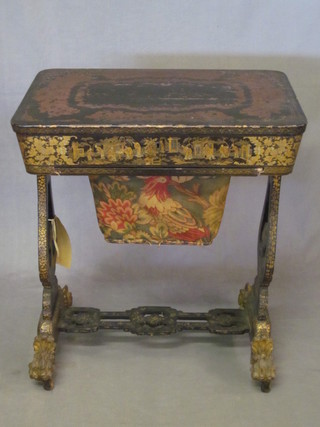A Regency black lacquered chinoiserie style work table with hinged lid revealing a fitted interior and with deep basket, raised  on standard end supports with scroll feet, 25"   ILLUSTRATED