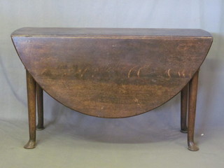 A Georgian oak oval drop flap gateleg dining table, raised on  club supports, 48"