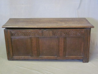 An antique oak coffer of panelled construction with hinged lid  43"