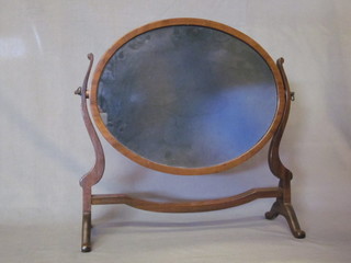 An oval plate dressing table mirror contained in a mahogany  swing frame 18"