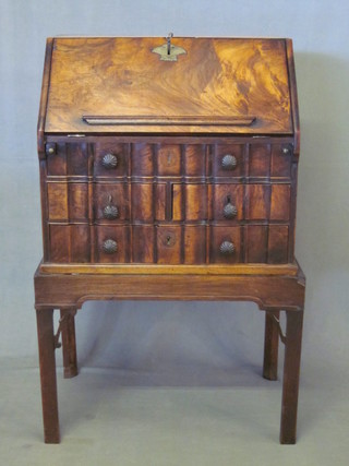 A Queen Anne style walnut bureau on stand, the upper section  with well fitted interior, having brass drop handles the to sides,  the base fitted 3 drawers, raised on a stand ending in square  supports 22 1/2"  ILLUSTRATED