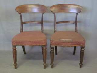 A pair of William IV mahogany bar back dining chairs with  straight mid rails and seats of serpentine outline, raised on turned  and reeded supports