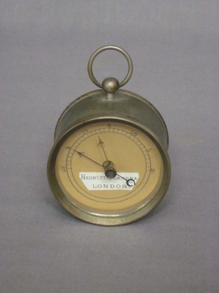An aneroid barometer by Negretti & Zambra contained in a metal drum case, 2 1/2"