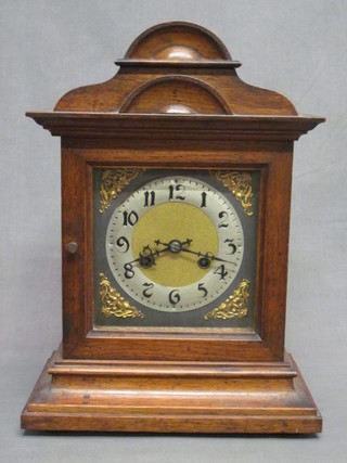 A 19th Century Continental 8 day striking bracket clock with  silvered dial and Arabic numerals, contained in an oak arch  shaped case