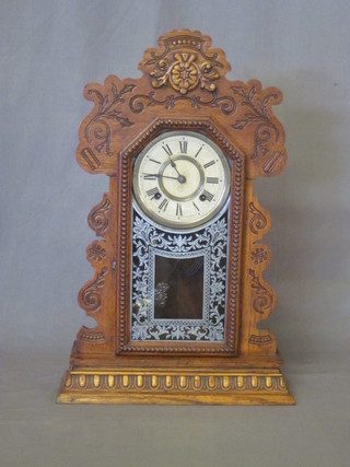 An American striking bracket clock with paper dial and Roman  numerals contained in an oak case 15"