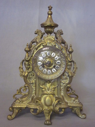 A French 8 day striking mantel clock contained in a gilt metal  case surmounted by an urn, raised on cabriole supports 11"