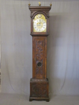 An 18th Century 8 day striking longcase clock with 5 pillar  movement, the 12" arch brass dial with minute indicator and  calendar aperture by E Bellington of Market Harborough,  contained in a carved oak case 87"  ILLUSTRATED