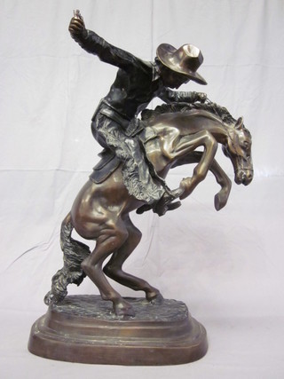 A bronze figure of a cowboy on a rearing horse, the base marked Donovan?